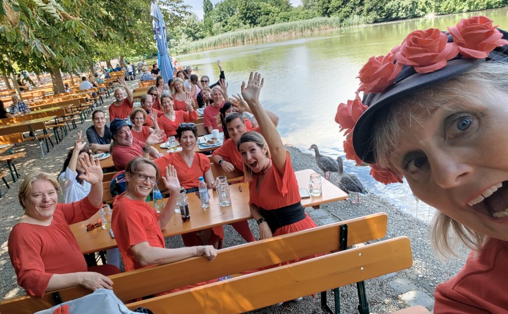 A group of people wearing red in a Biergarten